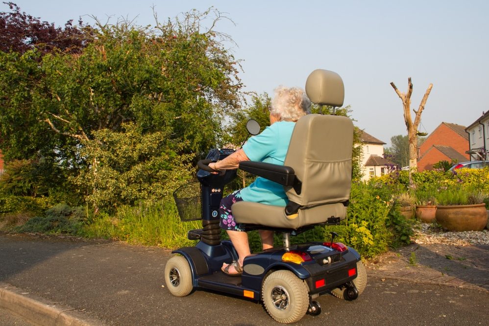 Old woman riding a scooter — Disability Support Services in Byron Bay, NSW