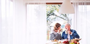 Senior Couple Eating Breakfast At Home — Disability Support Services in Coffs Harbour, NSW