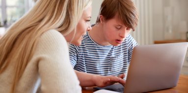 Teenage boy with down syndrome getting tutored at home — Disability Support Services in Gawler, SA