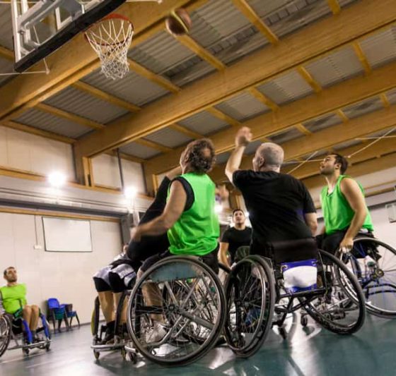Disabled happy guys playing basketball — Disability Support Services in Robina, QLD