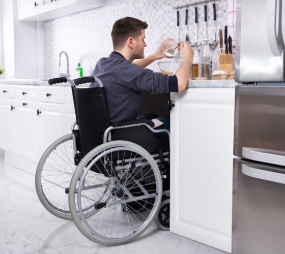 Young Disabled Man Sitting Preparing Food
