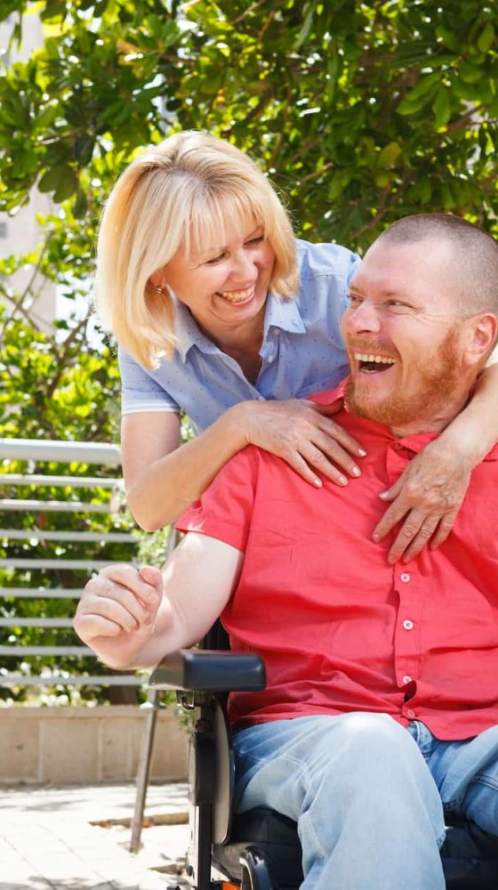 Guy on a wheelchair laughing — Disability Support Services in Gold Coast, QLD