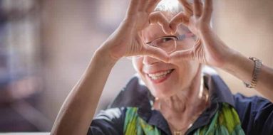 Old lady giving a heart sign — Disability Support Services in Robina, QLD