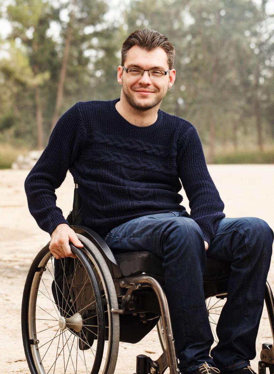 Guy on a wheelchair wearing blue sweatshirt — Disability Support Services in Robina, QLD